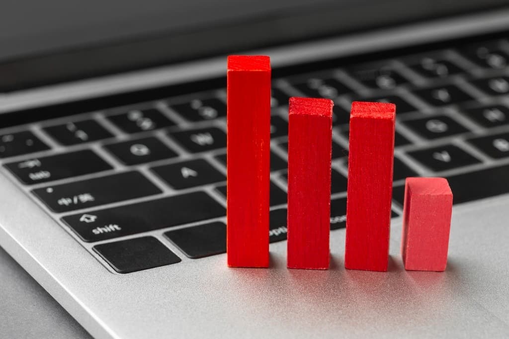 Red wooden blocks arranged like a bar chart on a laptop keyboard